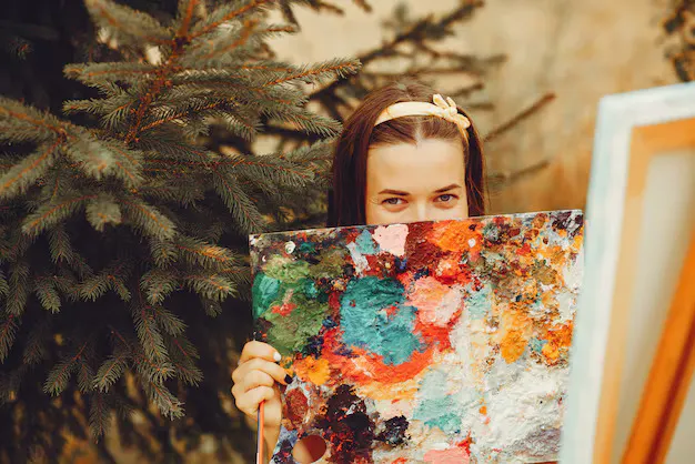 Painter holding a colourful paint palette