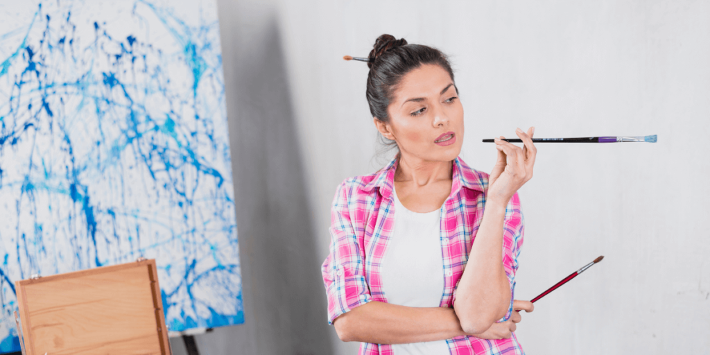 A woman and a man are painting a room together, using brushes and rollers to apply color to the walls.
